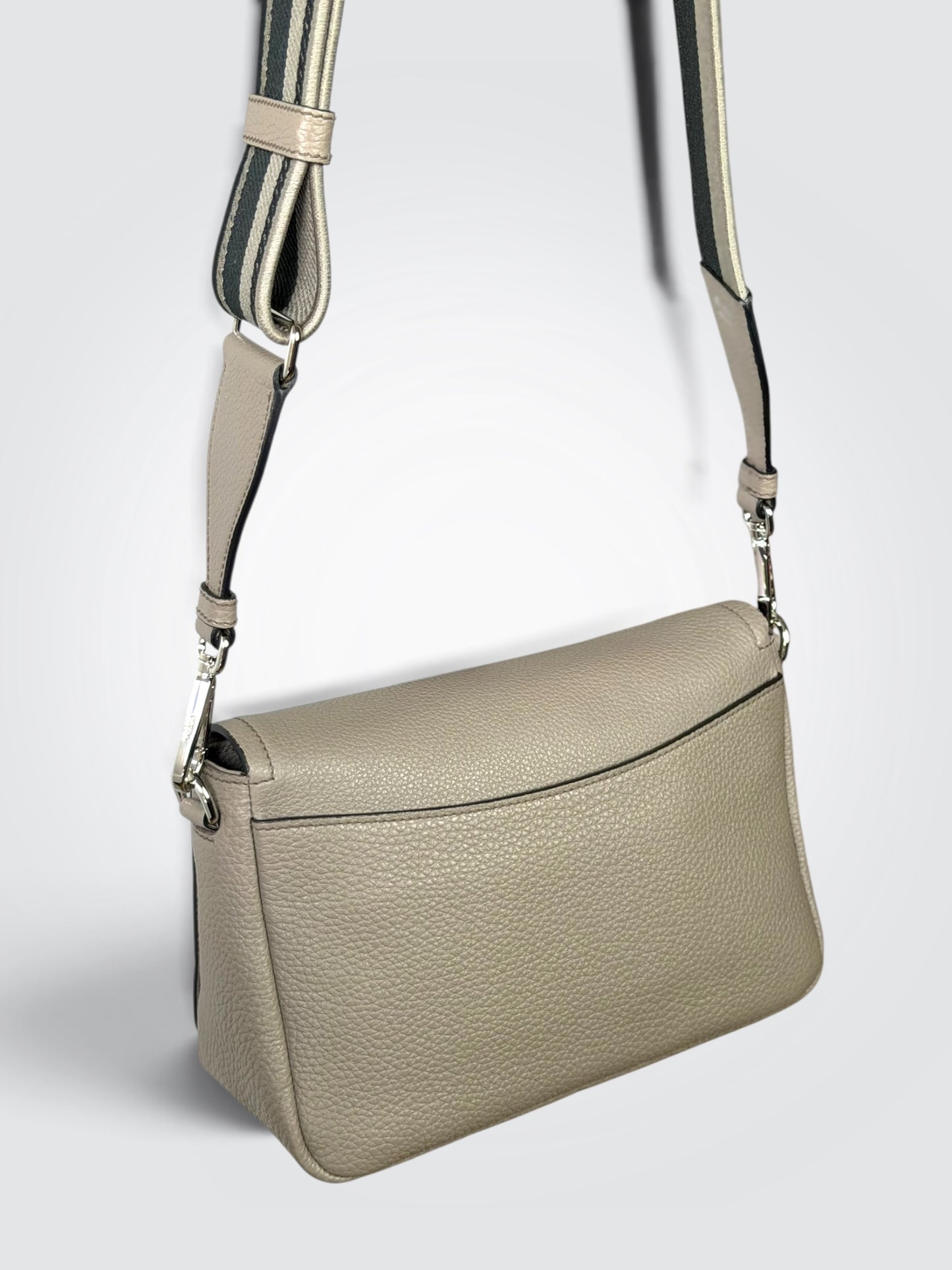 Prada Vitello Daino Soft Flap Crossbody in the argilla (clay grey) colorway, featuring textured calfskin leather and a logo-print embroidered woven strap