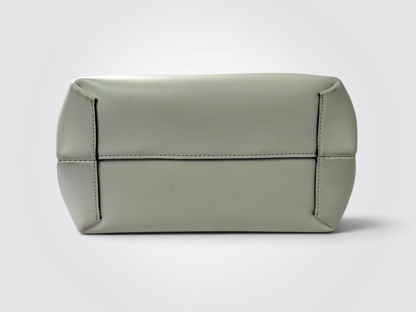 white Danse Lente bucket bag featuring a distinct marbled green resin top handle.