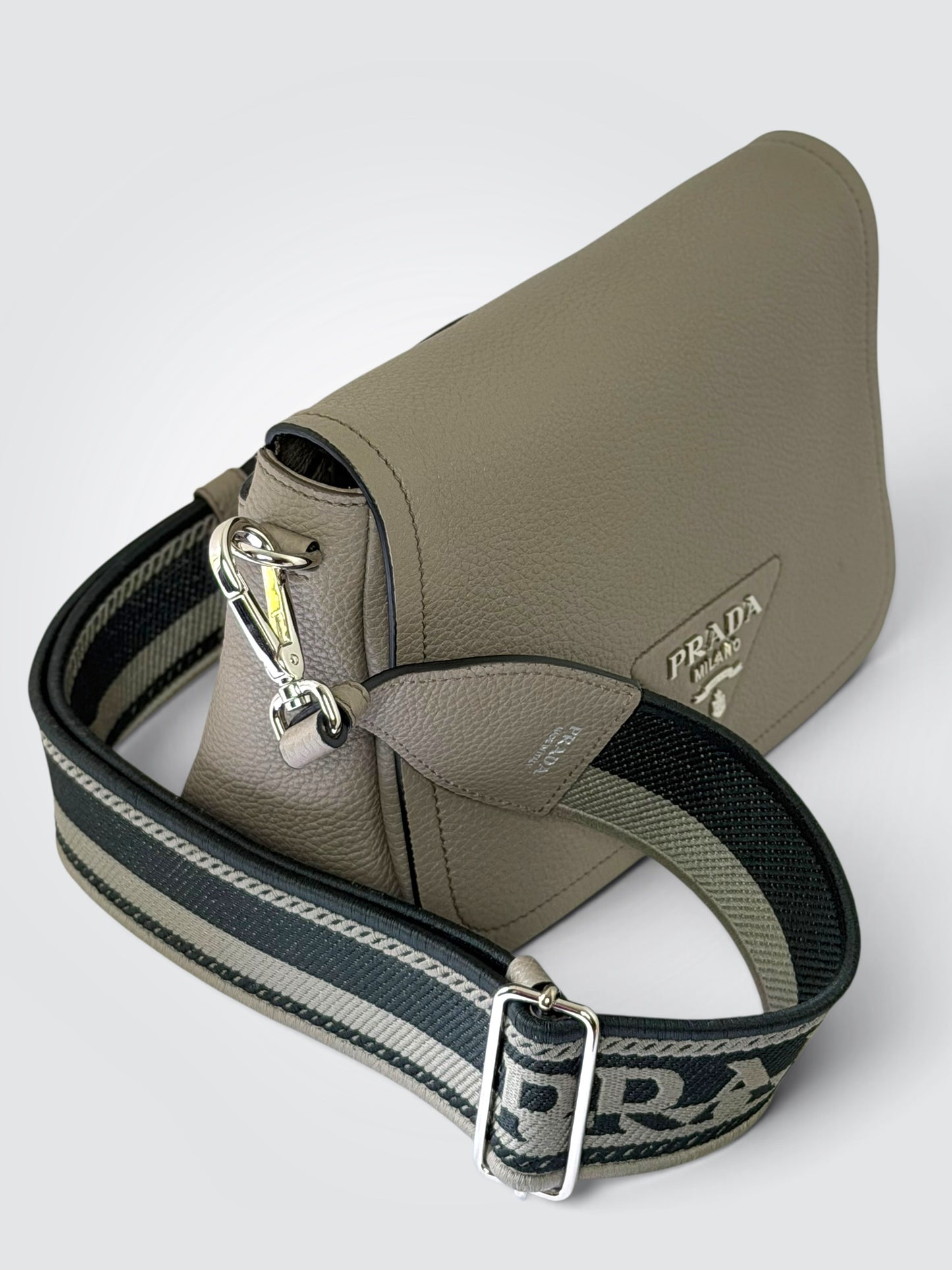 Pre-owned Prada Vitello Daino Soft Flap Crossbody Bag in Argilla clay-grey textured leather with silver-tone hardware and logo-print embroidered woven strap