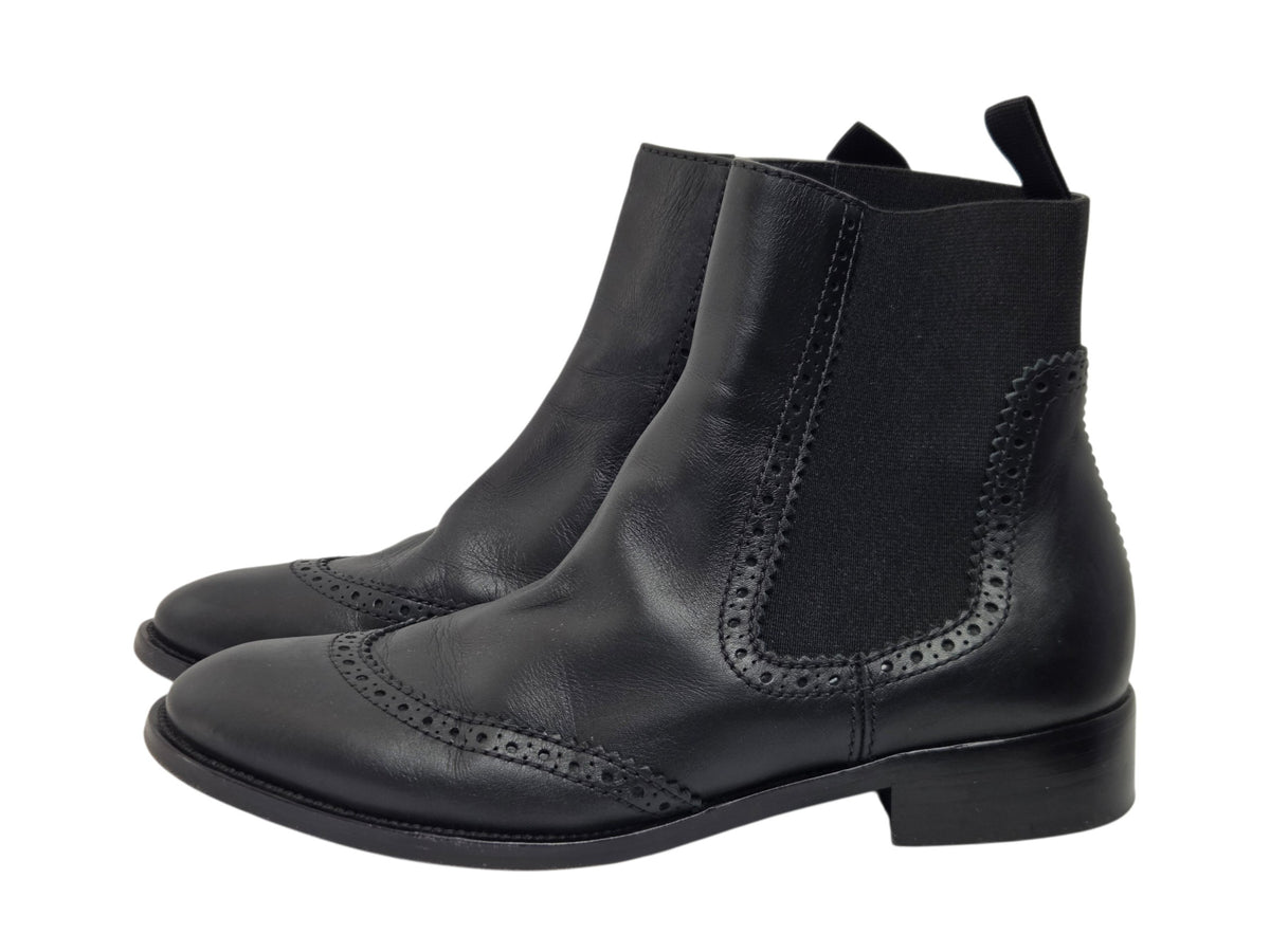 Pre-owned Balenciaga black leather wingtip brogue Chelsea boots with elastic side panels and low block heel, size 38.5 — available at Style Reissue Vancouver