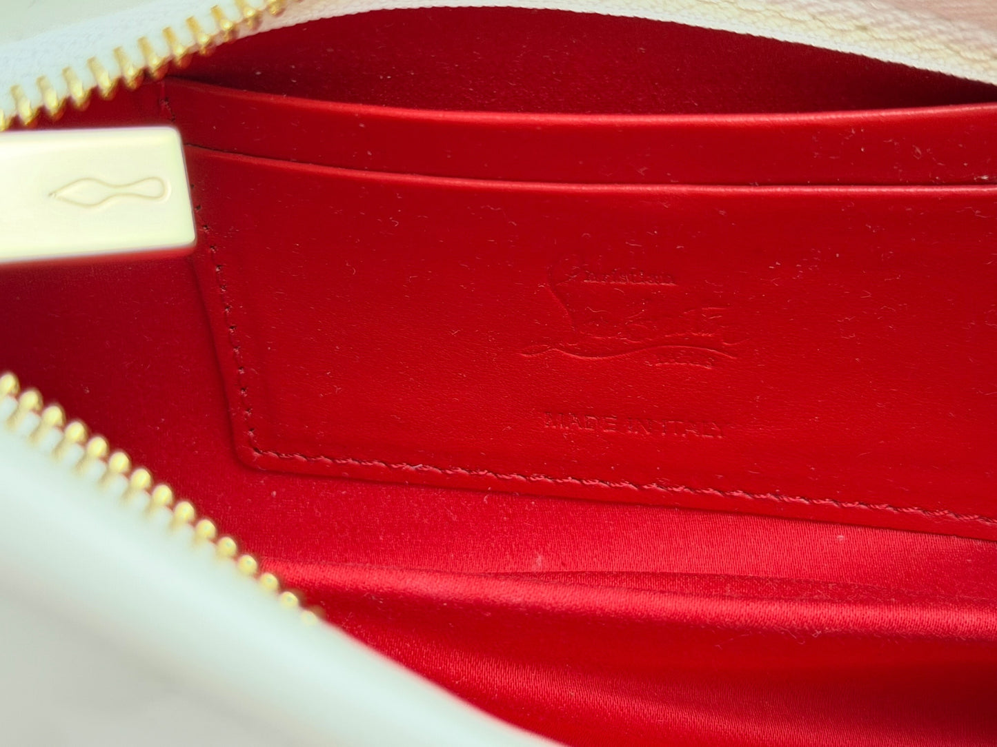 Christian Louboutin white patent leather Loubitwist small clutch with a detachable chain strap and signature star detail.