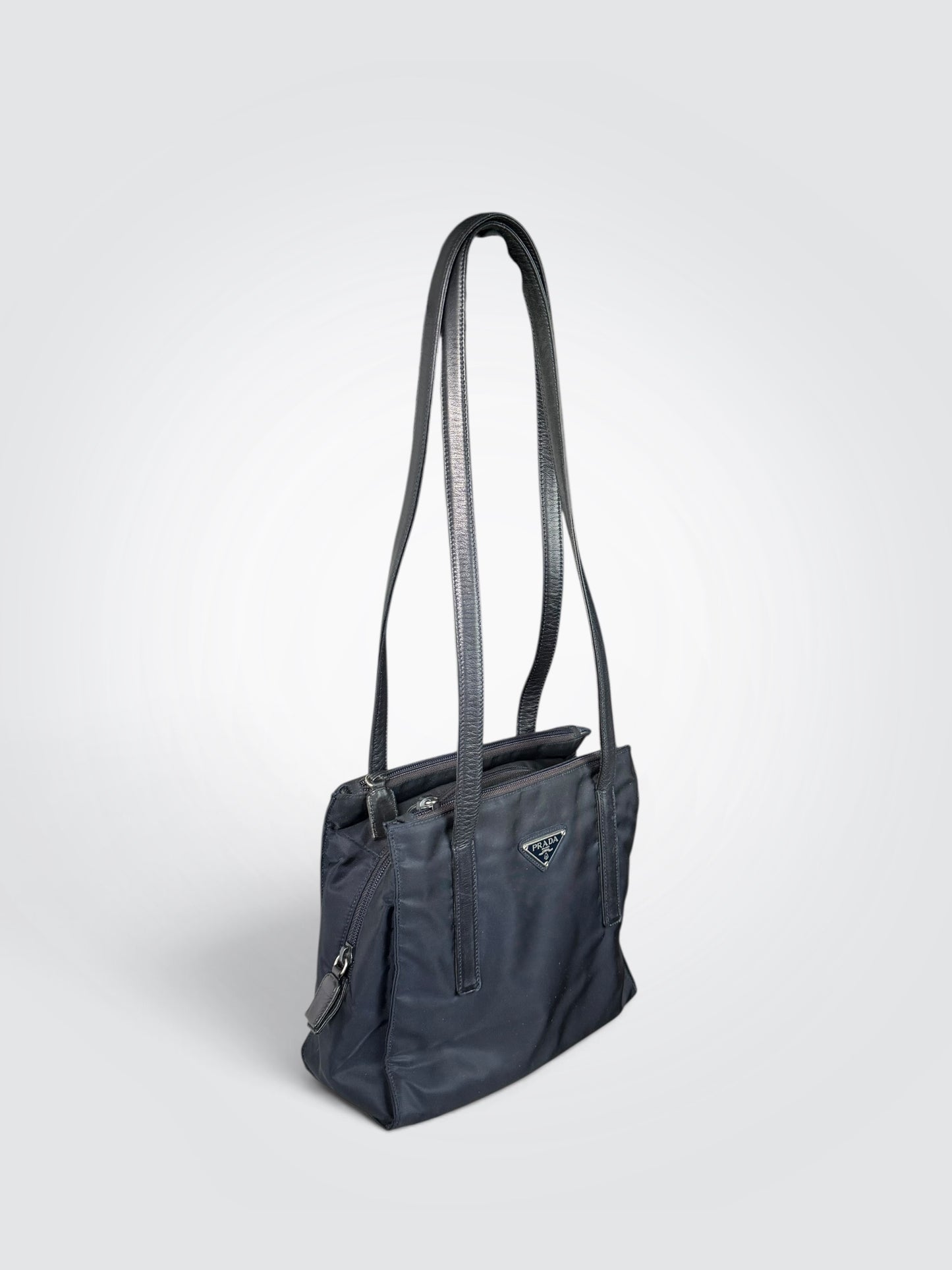 Pre-owned Prada black nylon tote shoulder bag with leather straps, triangle logo plaque, and three zippered compartments
