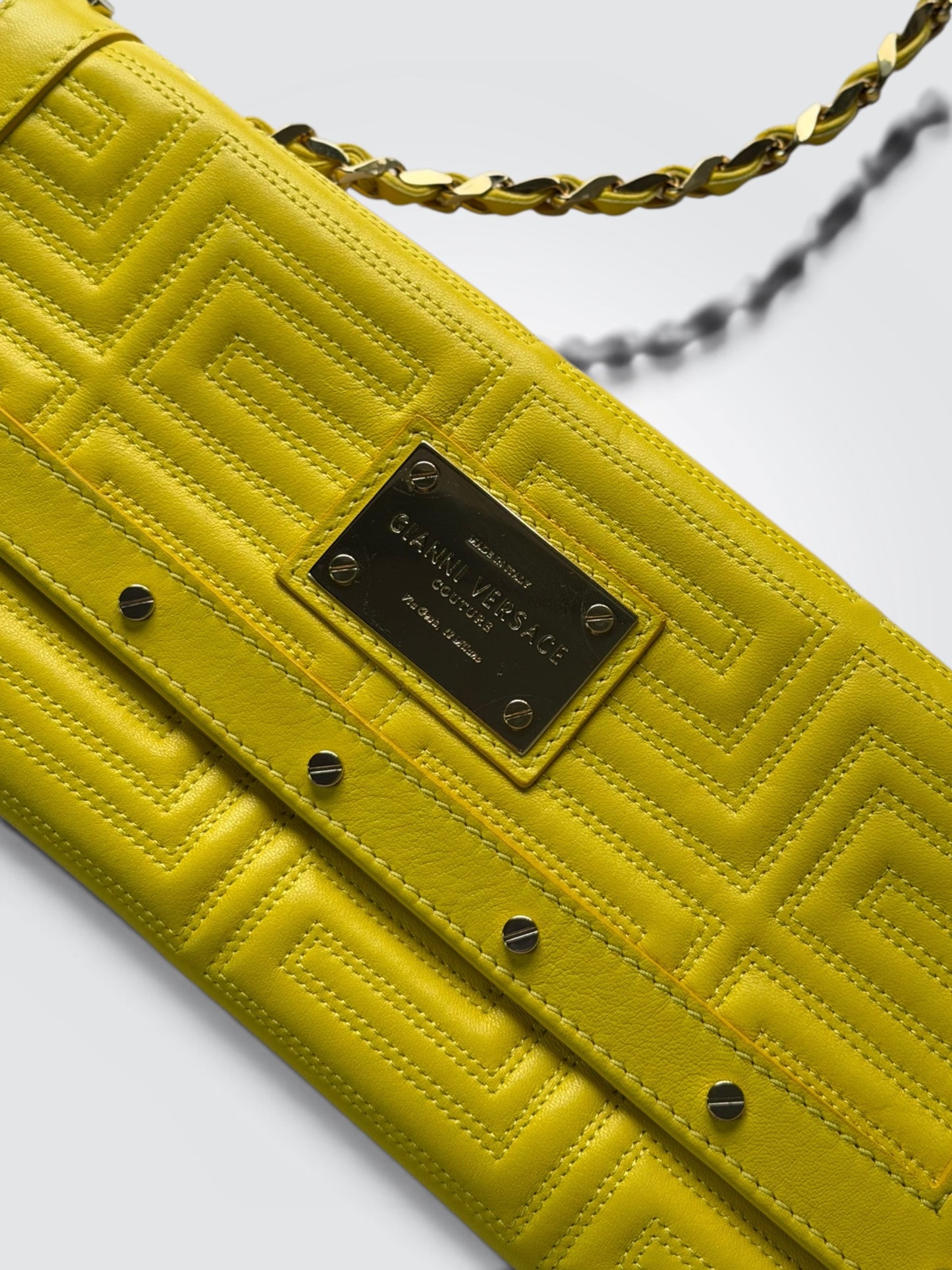 vintage Gianni Versace yellow quilted leather shoulder bag featuring a geometric Greek-key motif and a braided chain strap.