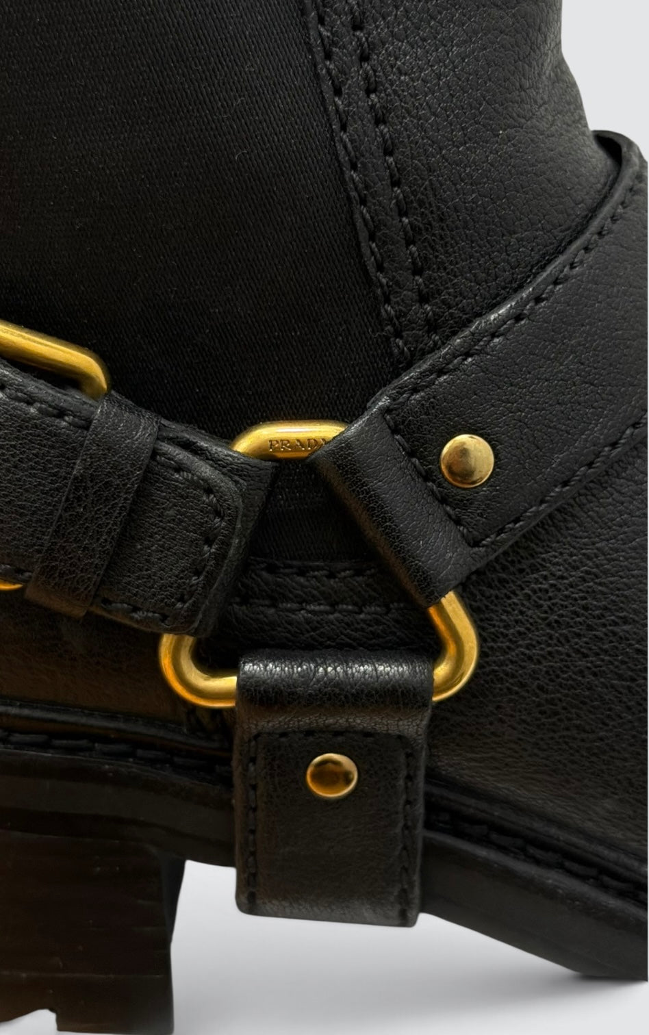 Pre-Owned Prada Black Leather Moto Ankle Boots with Gold-Tone Harness Strap — Size 38.5