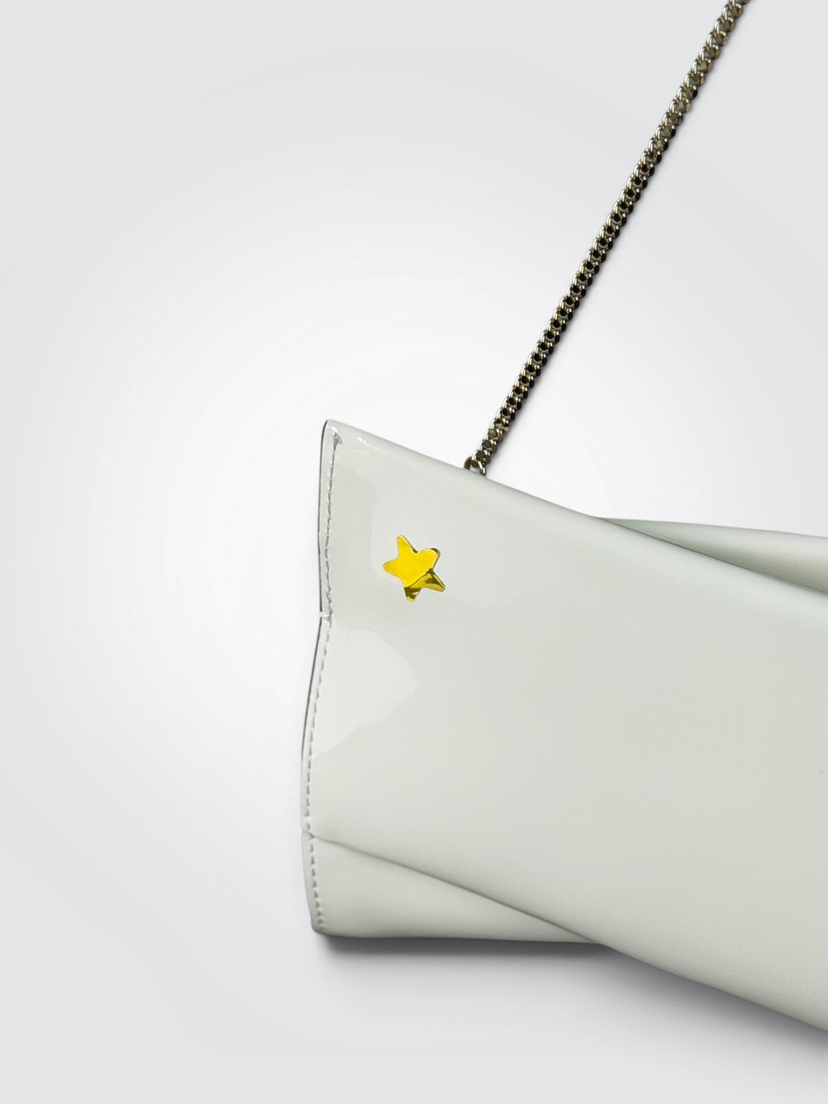 Christian Louboutin white patent leather Loubitwist small clutch with a detachable chain strap and signature star detail.