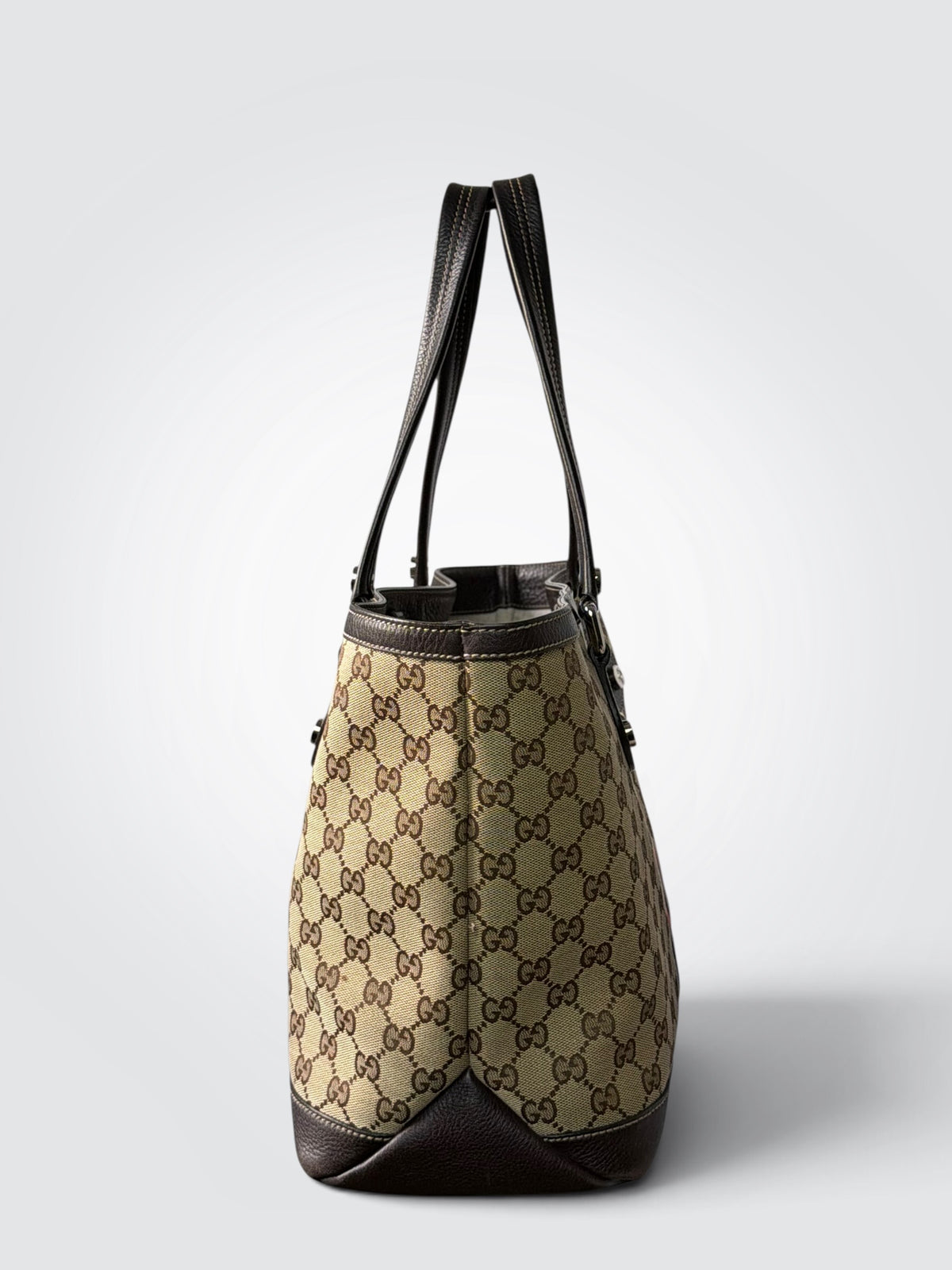 vintage Gucci GG canvas medium Sunset tote featuring dark brown leather trim and the signature green and red Web stripe.