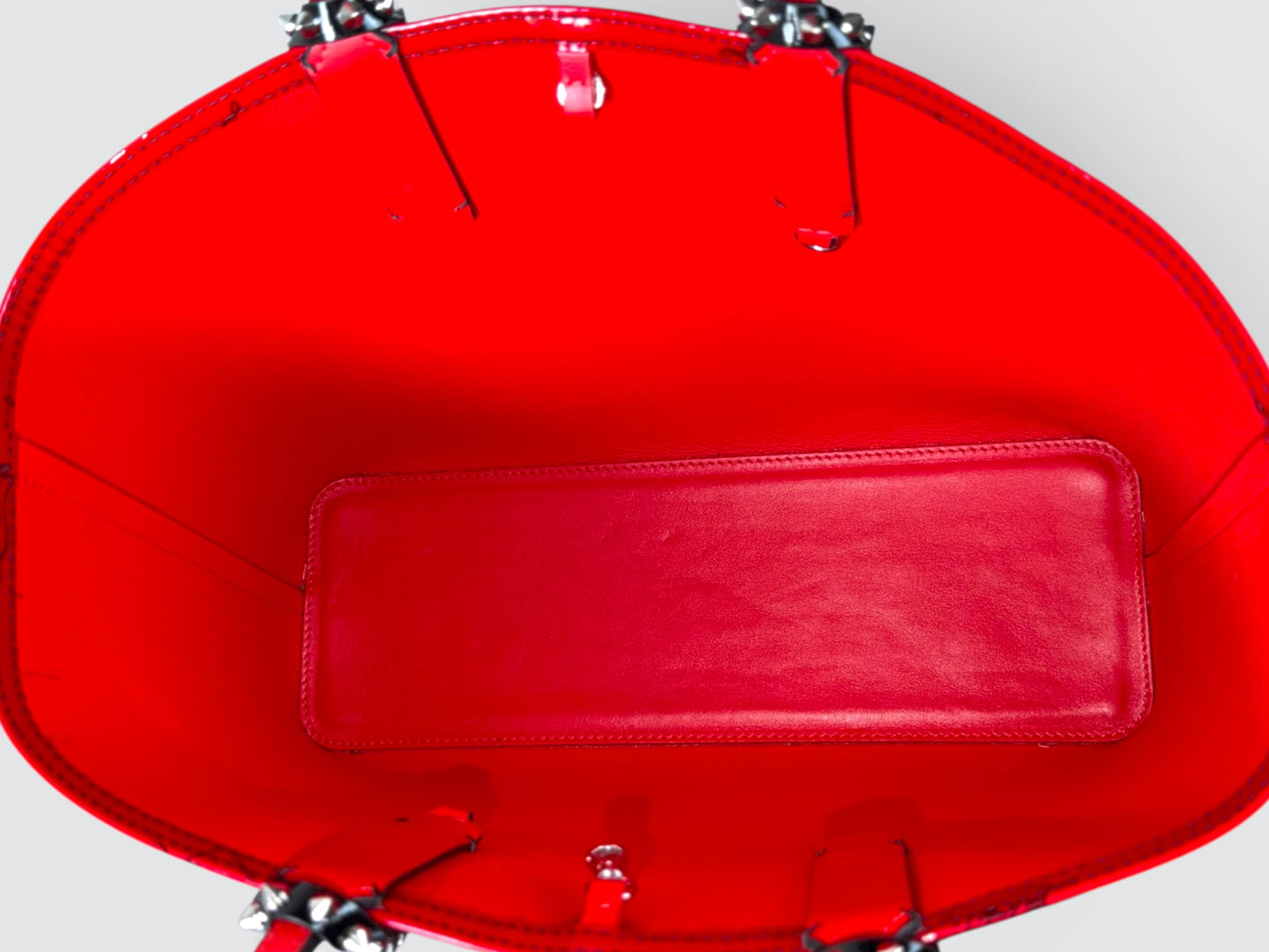 Christian Louboutin Cabata red and black gradient patent leather small tote featuring signature silver-tone spike detailing on the handle attachments.