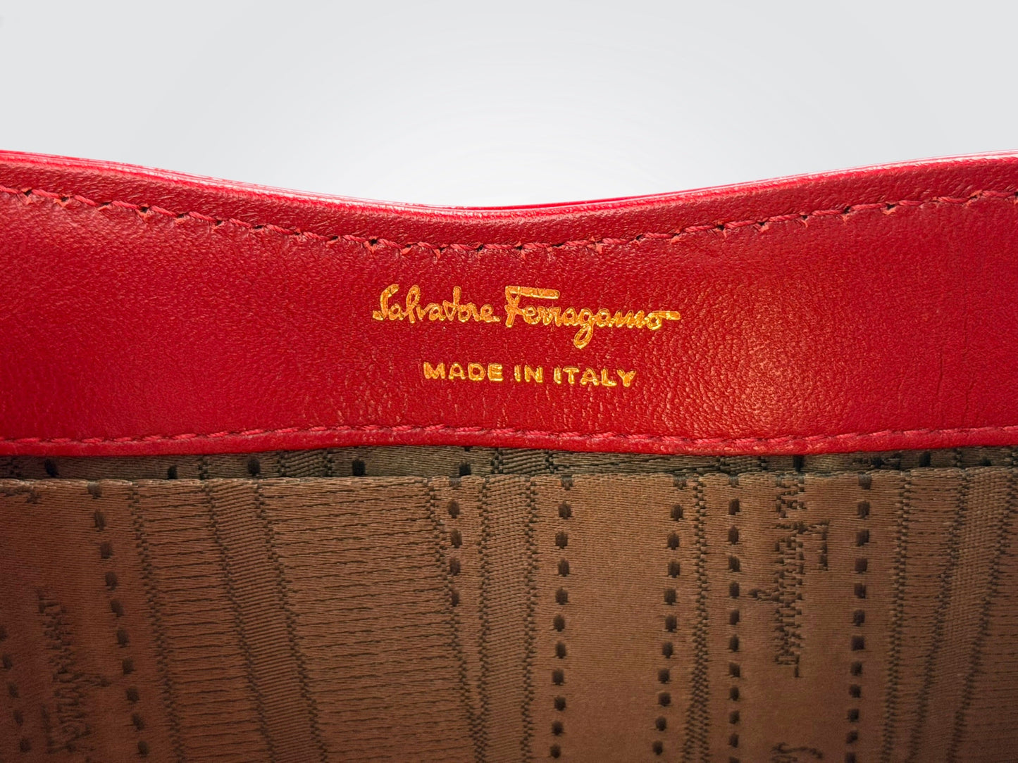 The glossy red patent leather Salvatore Ferragamo Vara Bow bag features a signature grosgrain ribbon bow accent and polished gold-tone chain strap.