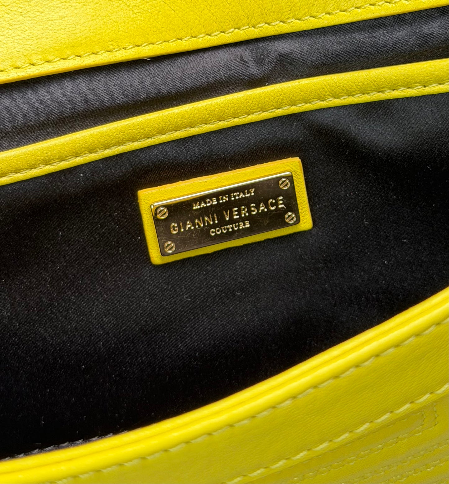 vintage Gianni Versace yellow quilted leather shoulder bag featuring a geometric Greek-key motif and a braided chain strap.