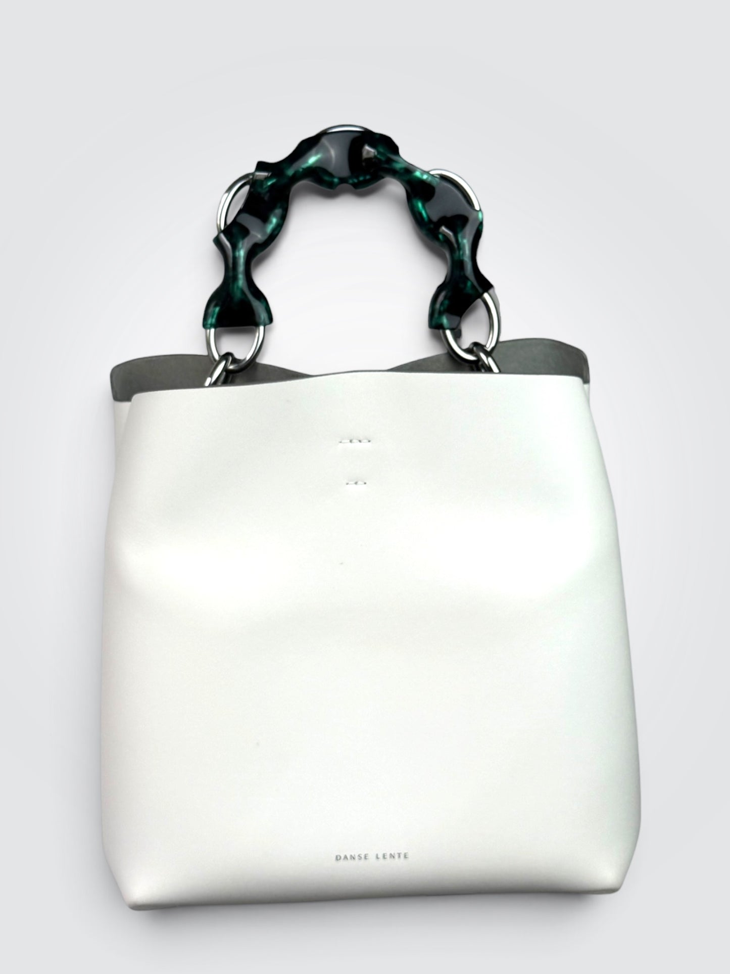 white Danse Lente bucket bag featuring a distinct marbled green resin top handle.