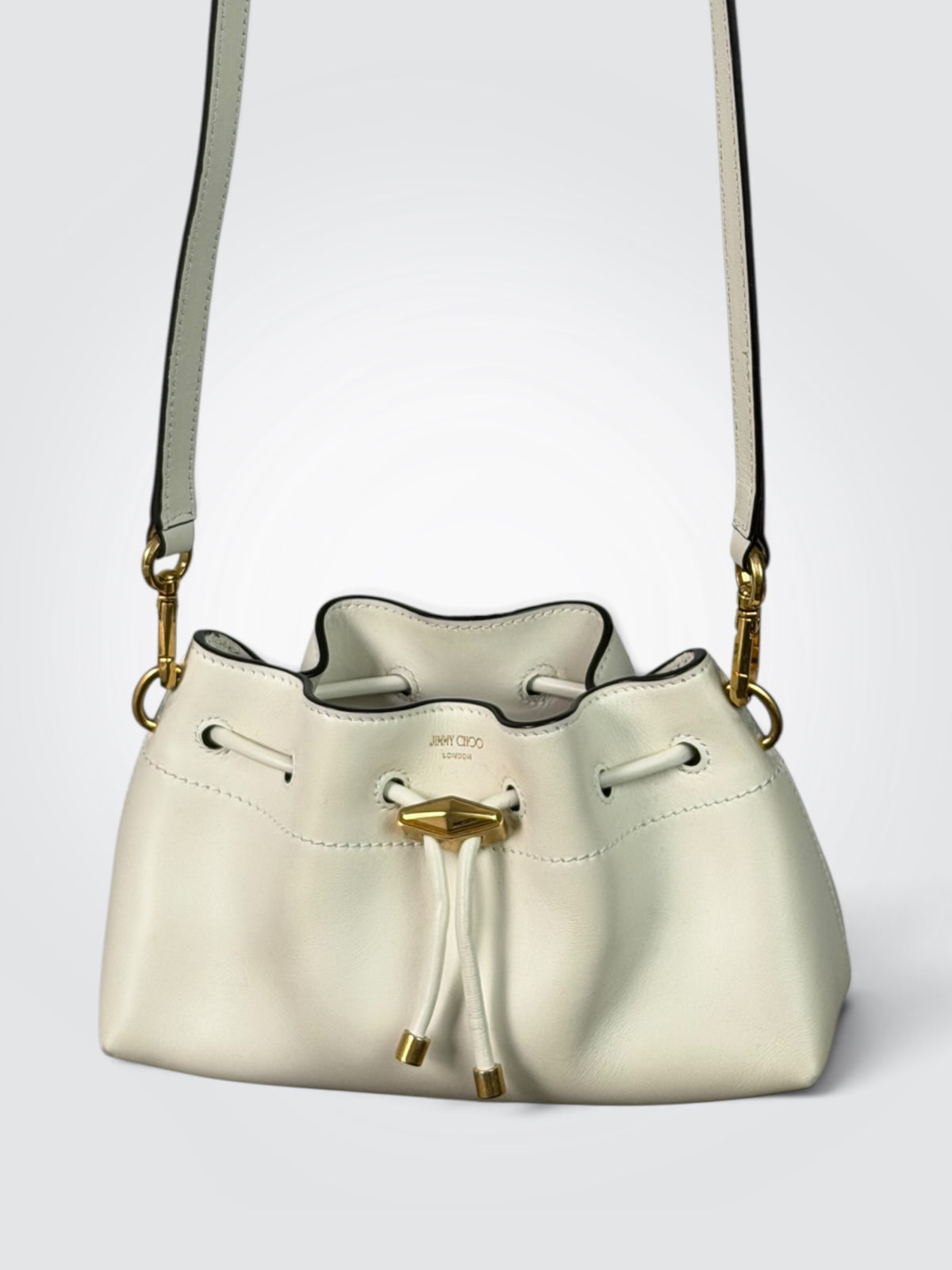 Pre-owned Jimmy Choo Cinch medium shoulder bag in latte white leather with gold-tone diamond hardware and drawstring closure