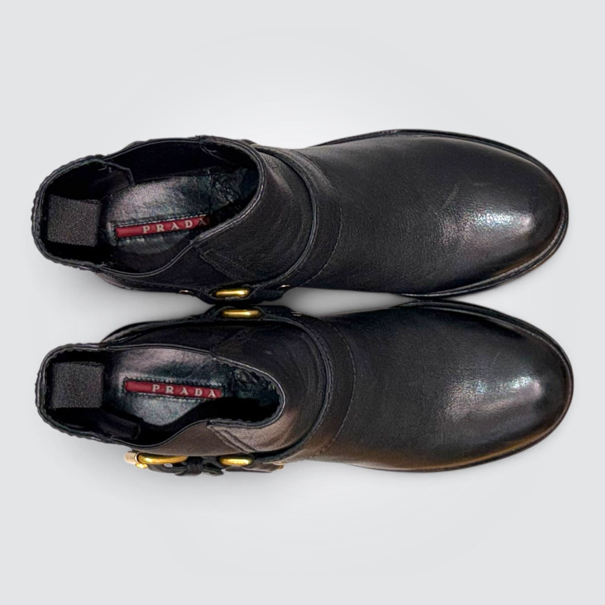 Pre-Owned Prada Black Leather Moto Ankle Boots with Gold-Tone Harness Strap — Size 38.5
