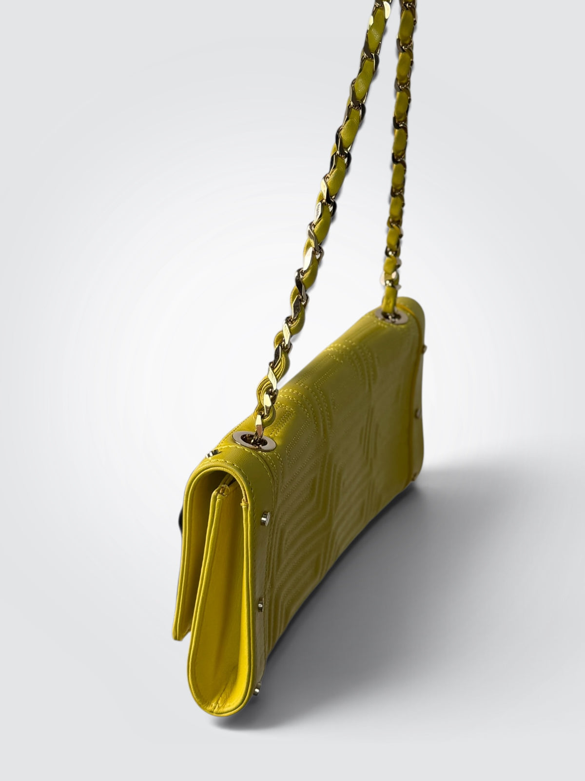 vintage Gianni Versace yellow quilted leather shoulder bag featuring a geometric Greek-key motif and a braided chain strap.