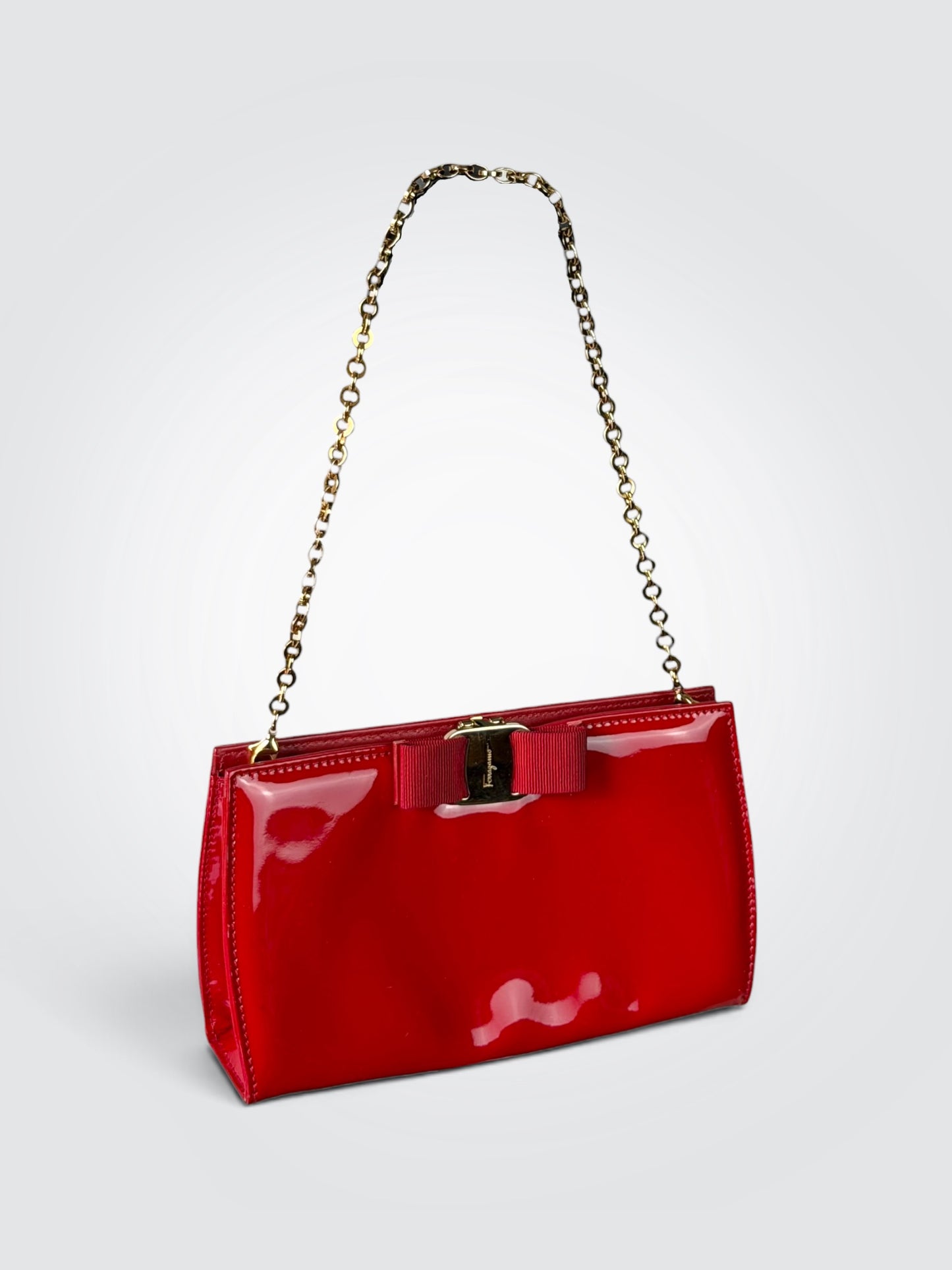 Pre-loved Salvatore Ferragamo Vara Bow shoulder bag in glossy red patent leather with grosgrain ribbon bow and polished gold-tone chain strap