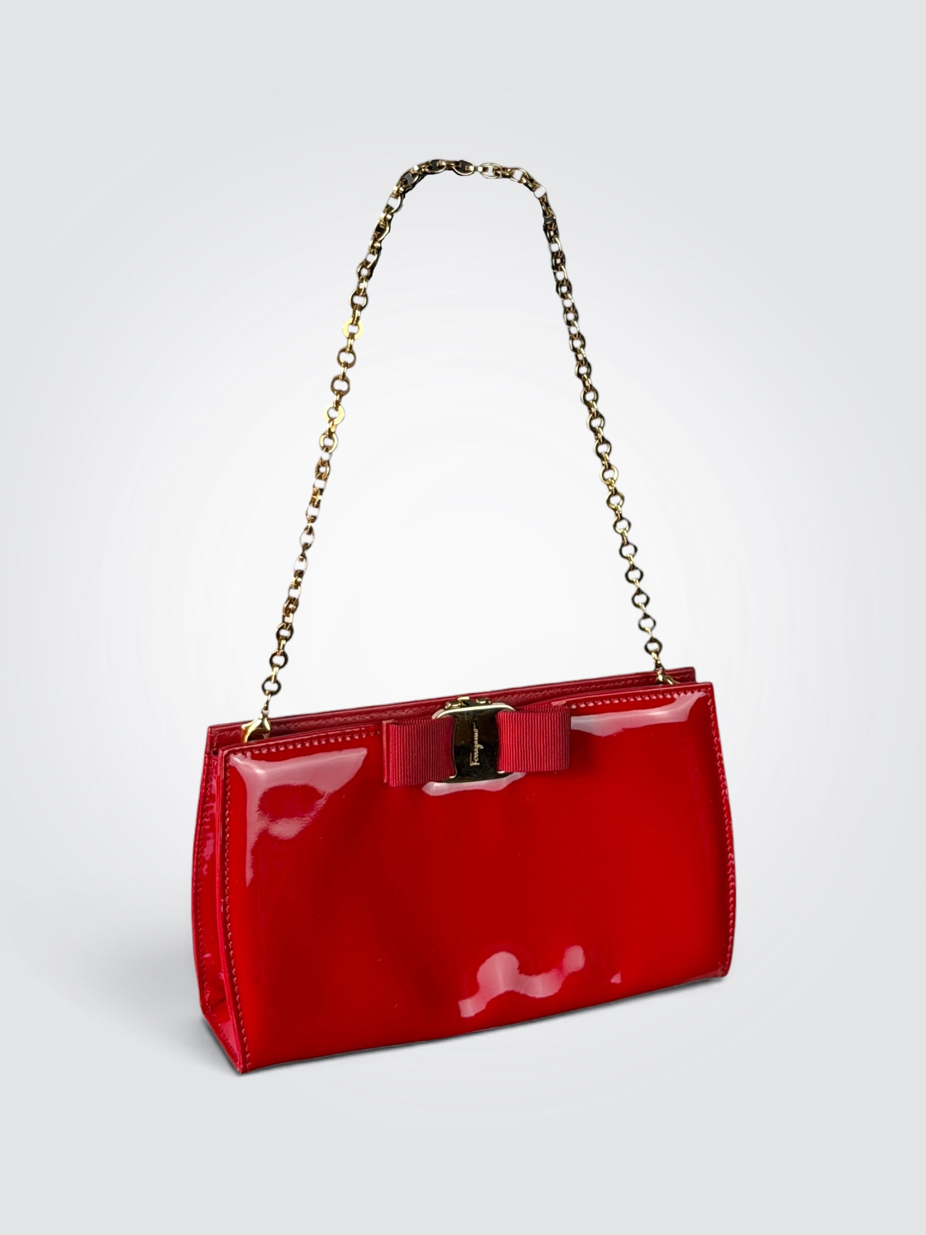 Pre-loved Salvatore Ferragamo Vara Bow shoulder bag in glossy red patent leather with grosgrain ribbon bow and polished gold-tone chain strap