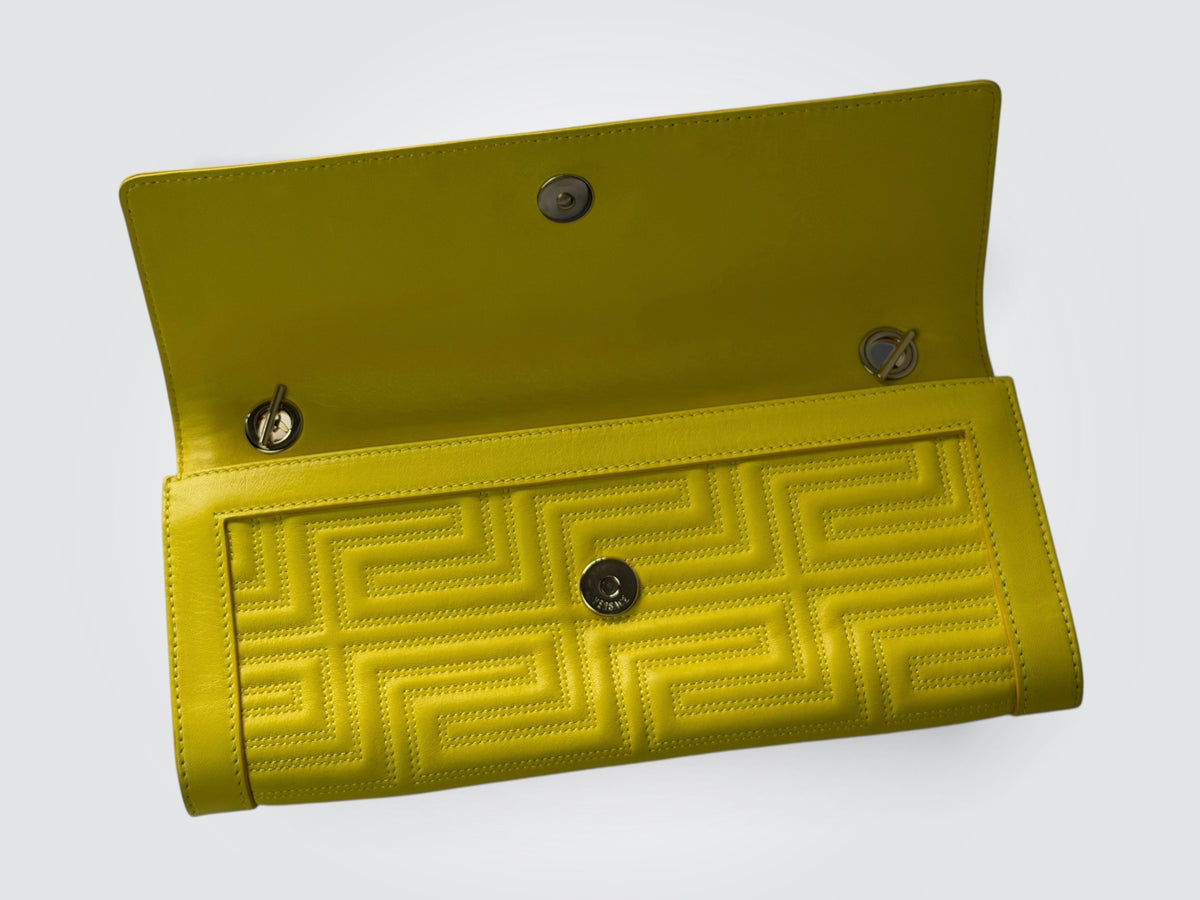 vintage Gianni Versace yellow quilted leather shoulder bag featuring a geometric Greek-key motif and a braided chain strap.