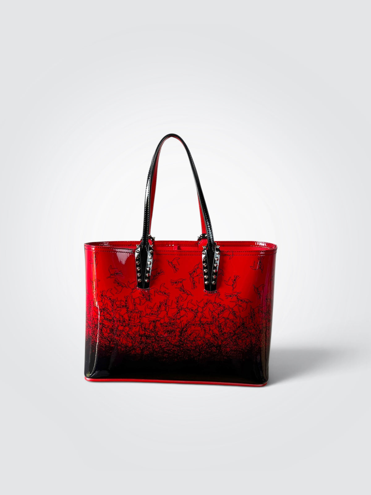 Pre-owned Christian Louboutin Small Cabata Loubinthesky tote in red and black gradient patent leather with silver-tone spike detailing on the handle attachments