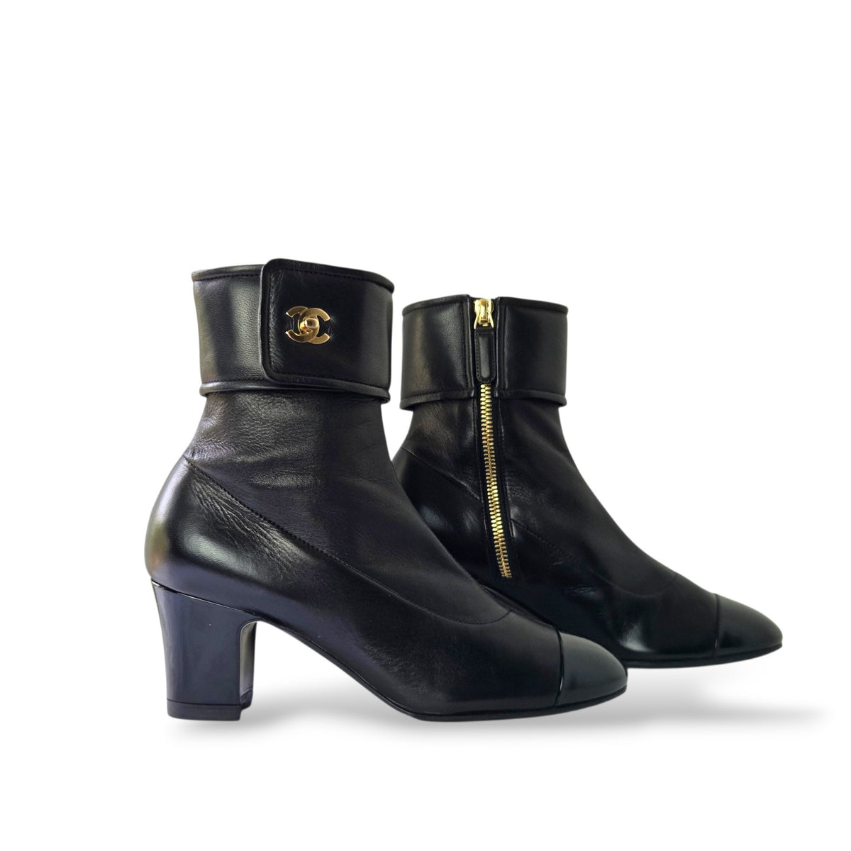 Pre-owned Chanel black leather ankle boots in EU 36 with fold-over cuff, gold CC logo, patent leather cap toe, and side zipper
