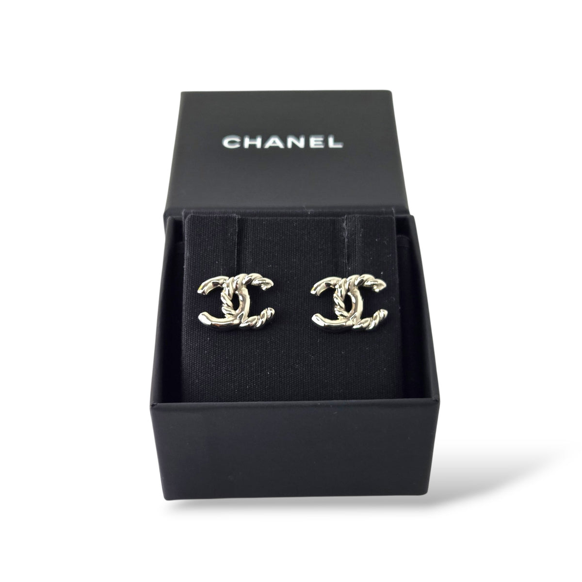 Pre-owned Chanel silver-tone twisted rope CC logo stud earrings with shiny metal finish and original box
