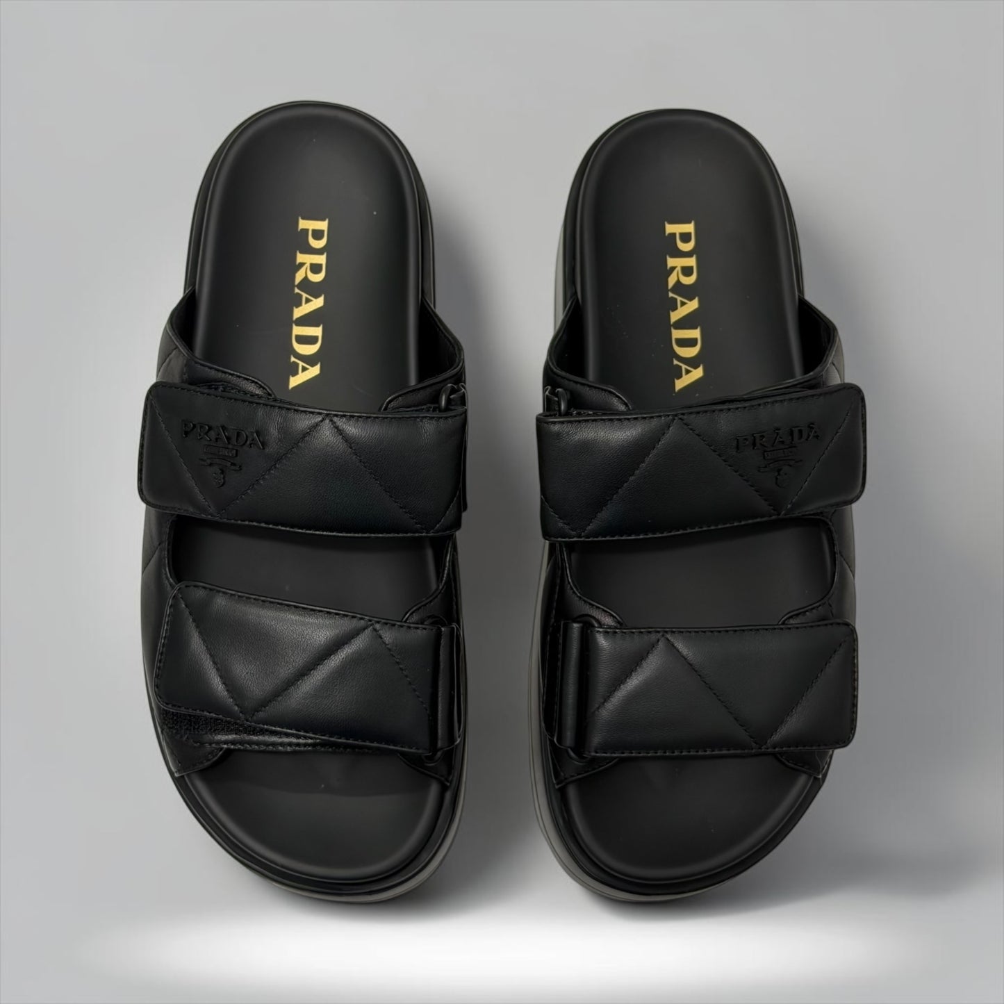 Pre-Owned Prada black nappa leather quilted padded double strap slide sandals embossed logo size 37.5 made in Italy — Style Reissue Vancouver