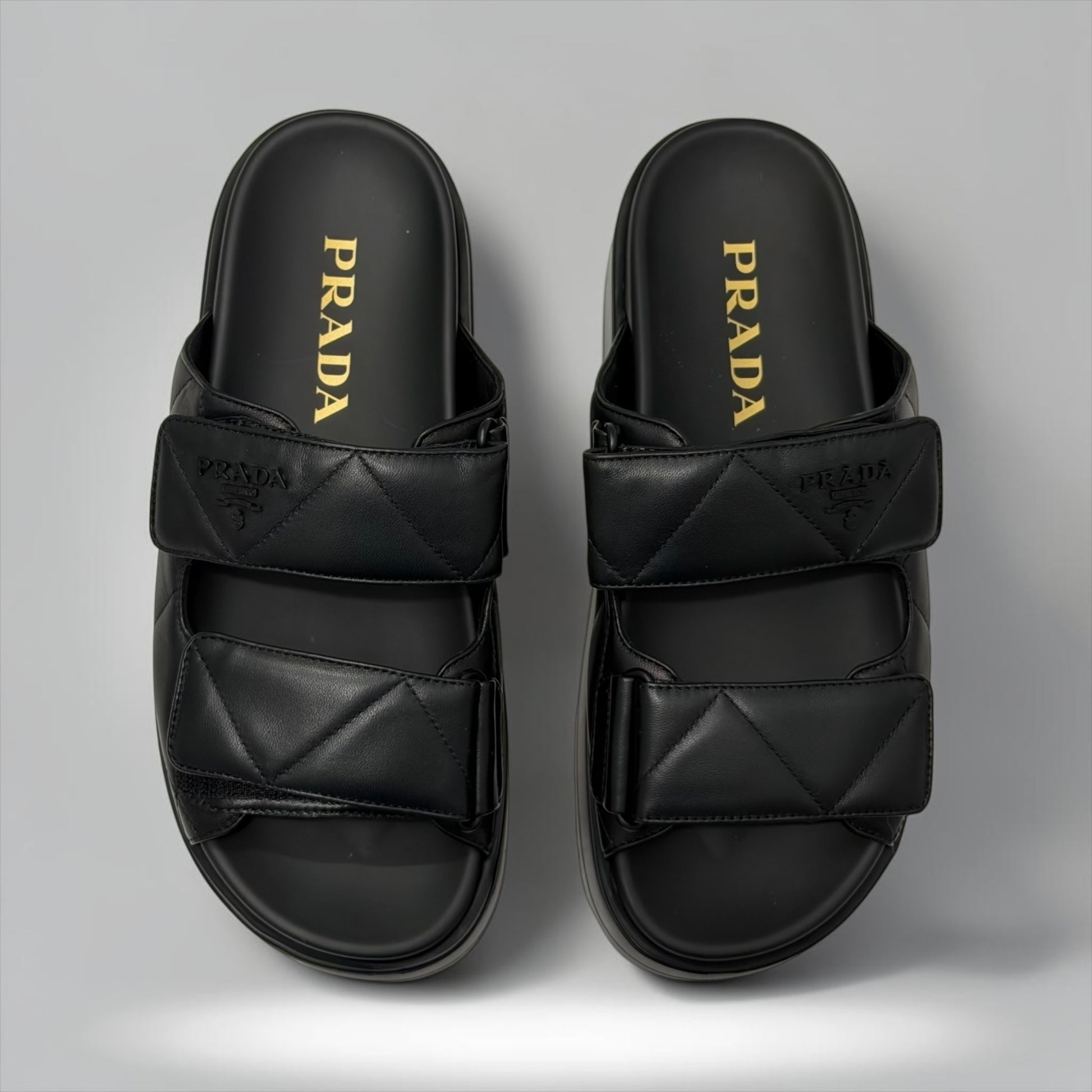 Pre-Owned Prada black nappa leather quilted padded double strap slide sandals embossed logo size 37.5 made in Italy — Style Reissue Vancouver