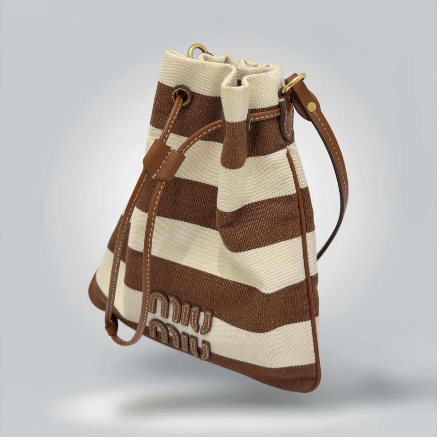 Pre-Owned Miu Miu brown cream striped canvas bucket bag leather logo lettering drawstring gold hardware made in Italy — Style Reissue Vancouver